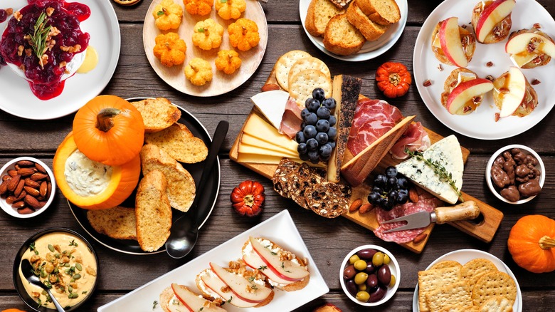 festive Thanksgiving-themed grazing table with charcuterie board and dip.