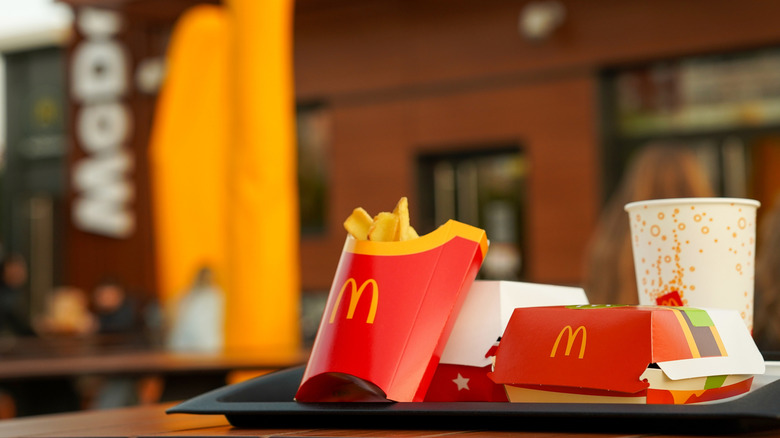 Tray of McDonald's fries, burger, soda on table