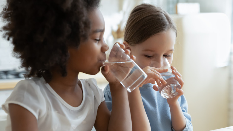 Children drinking glasses of water