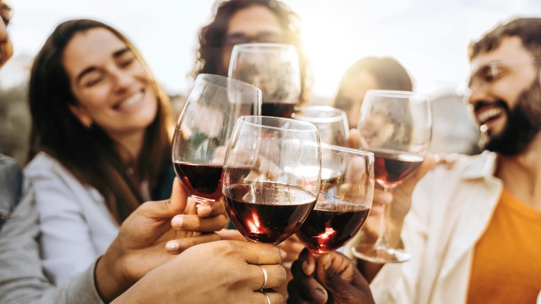 People toasting with wine glasses