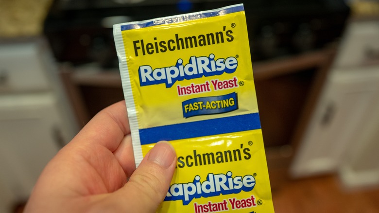 Person holding packets of yeast