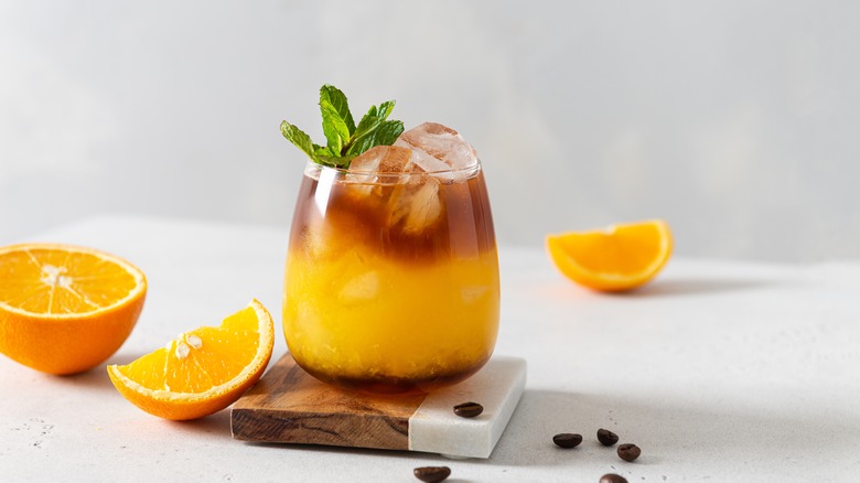 Coffee and orange juice in a glass