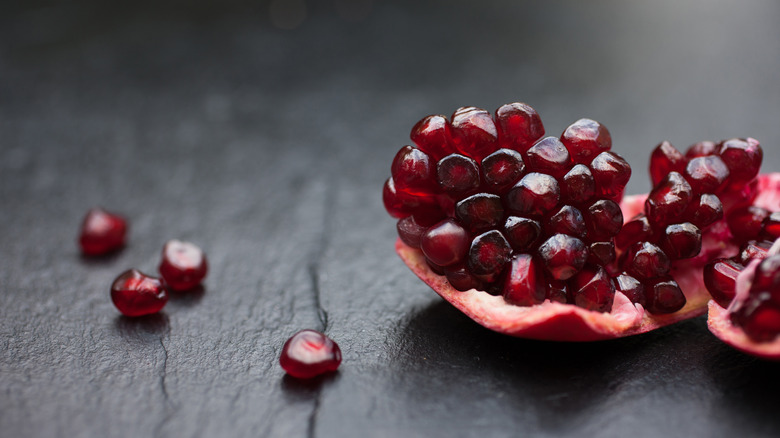 Pomegranate seeds on a black background