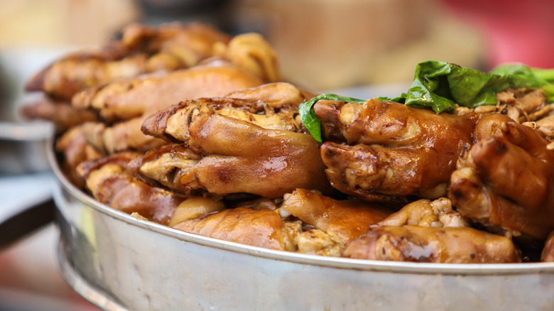 Braised pigs feet in metal dish