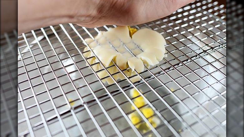 smashing egg using wire cooling rack