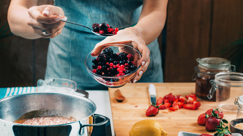 Woman makes berry jam