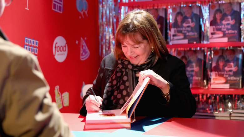 Ina Garten signing a cookbook