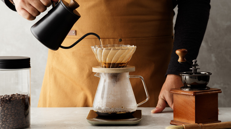 barista making pourover coffee