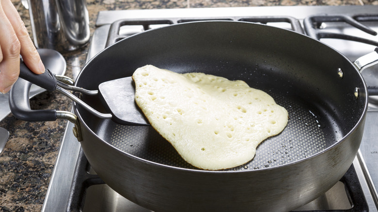 Flipping a pancake with spatula