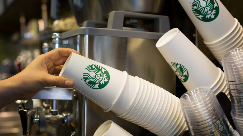 barista taking cup to fill at Starbucks