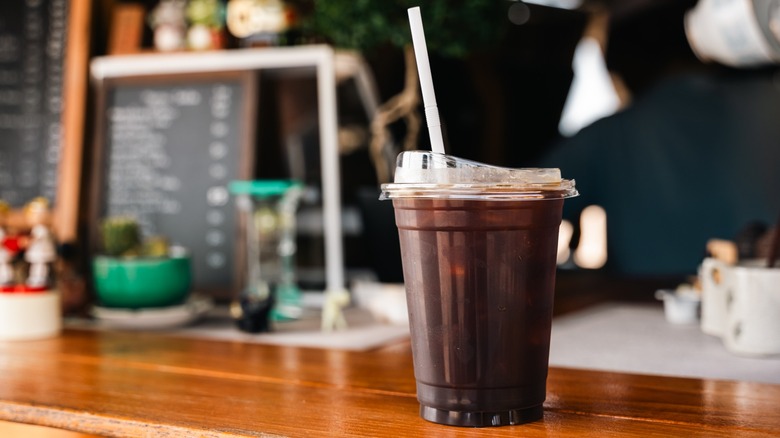 An iced Americano coffee in a plastic cup