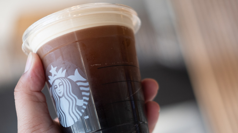 person holding starbucks nitro cold brew