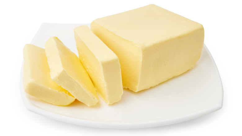 sliced butter on white dish 