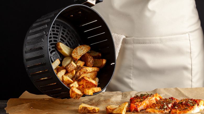 Dumping potatoes from air fryer onto parchment