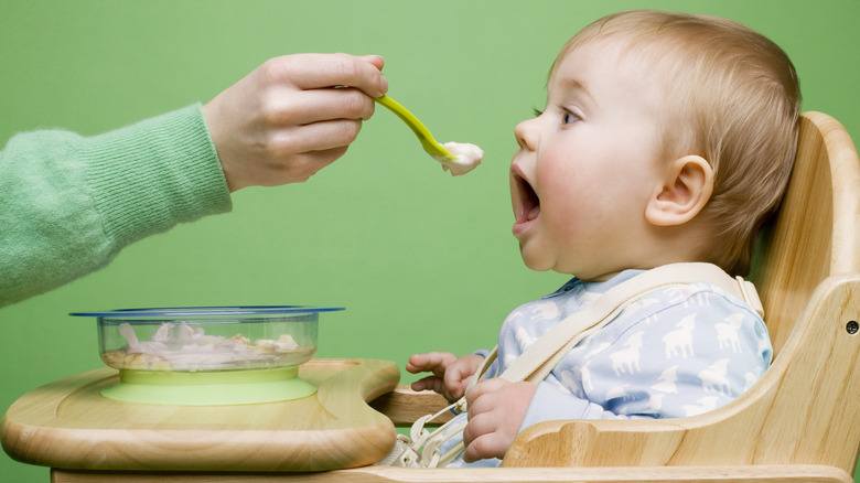 feeding baby-food to a baby