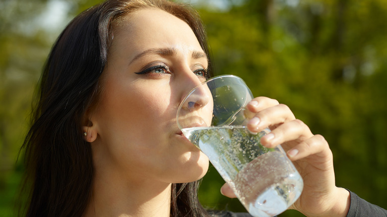 girl drinking cup of seltzer water 