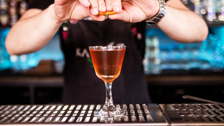 Bartender making a red cocktail 