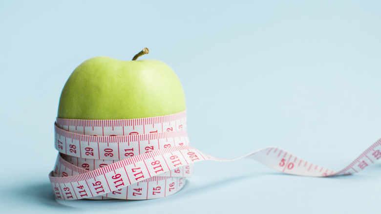 Measuring tape wrapped around an apple