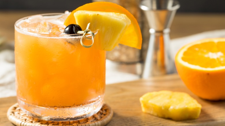 A Rum Runner cocktail with sliced orange and pineapple