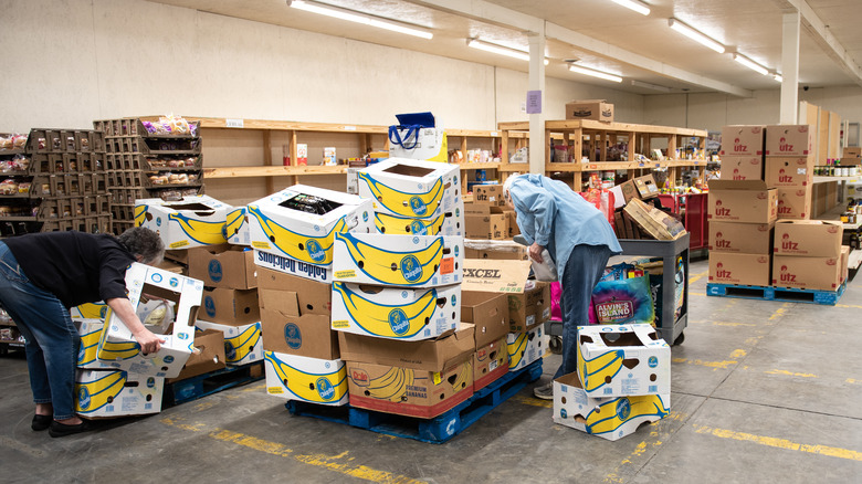 people boxing food in warehouse