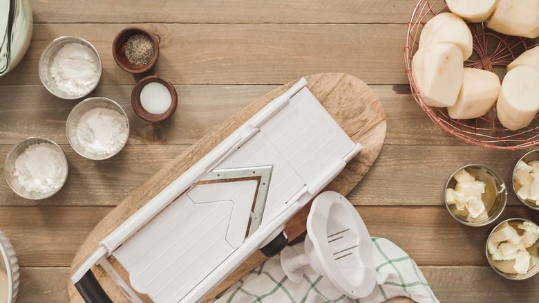 Mandoline slicer with peeled potatoes