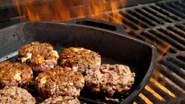 food in cast iron pan on grill