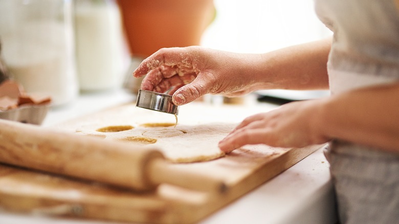 Person using cutting tool to slice biscuits