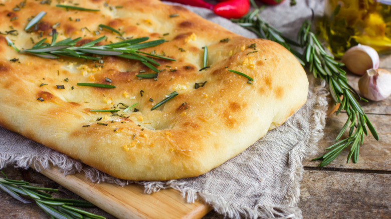 garlic and rosemary focaccia on wooden table