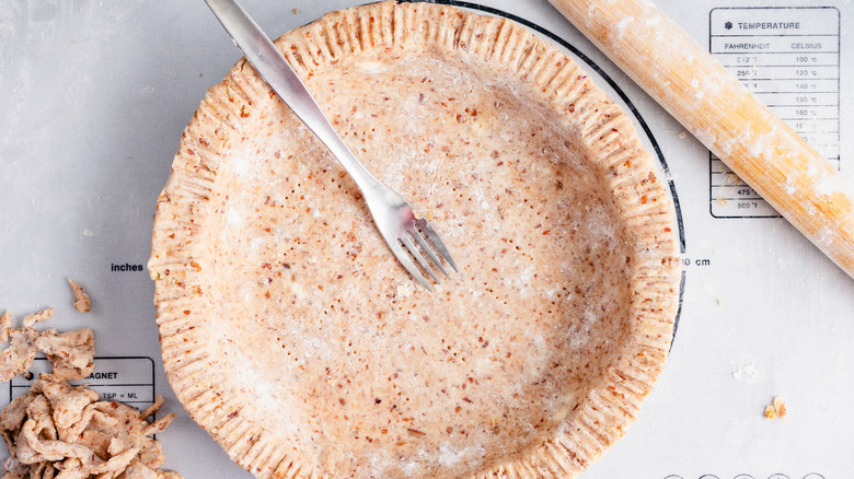 raw pie crust and fork