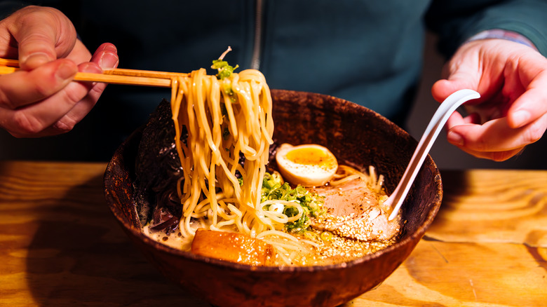 Person eating ramen