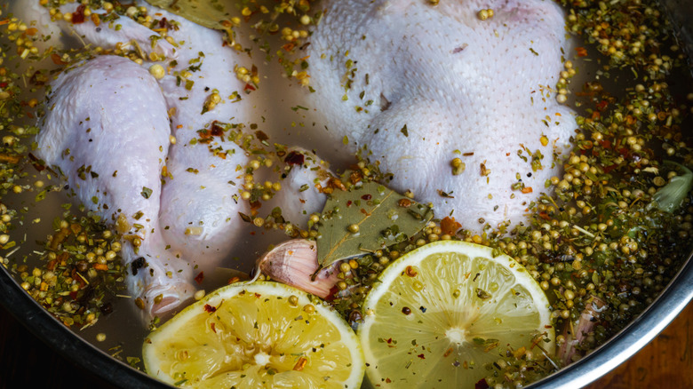 raw chicken soaking in brine solution