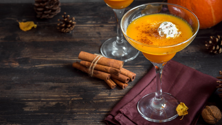 Pumpkin cocktail with cinnamon sticks