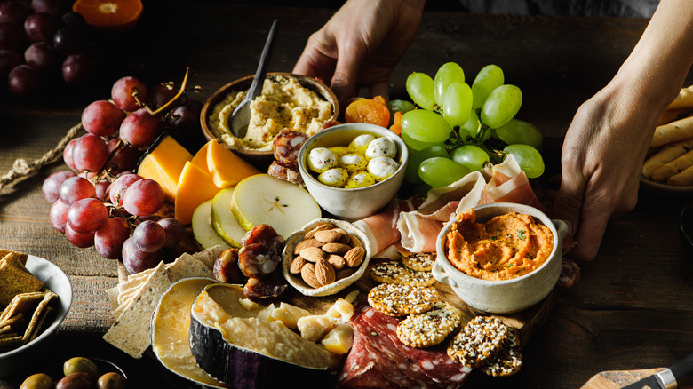 Hands placing cheese board