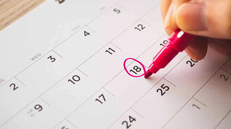 calendar being marked with red pen