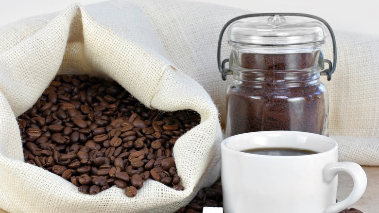 coffee cup and beans in burlap