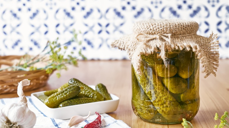 Pickles in jar and on countertop