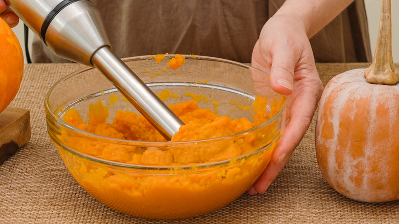 pumpkin puree glass bowl, women mixing