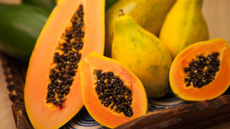 sliced and whole papayas