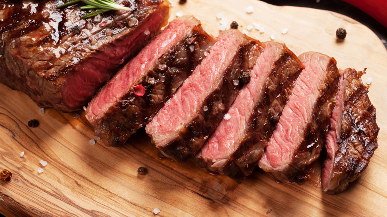 sliced steak on cutting board