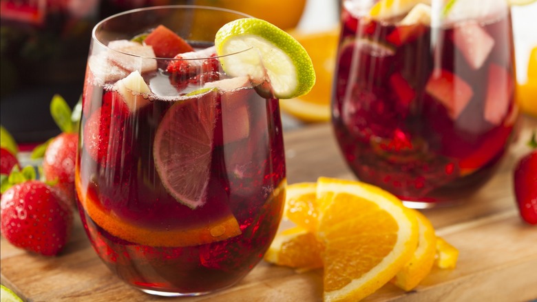 Two glasses of sangria with various sliced fruits