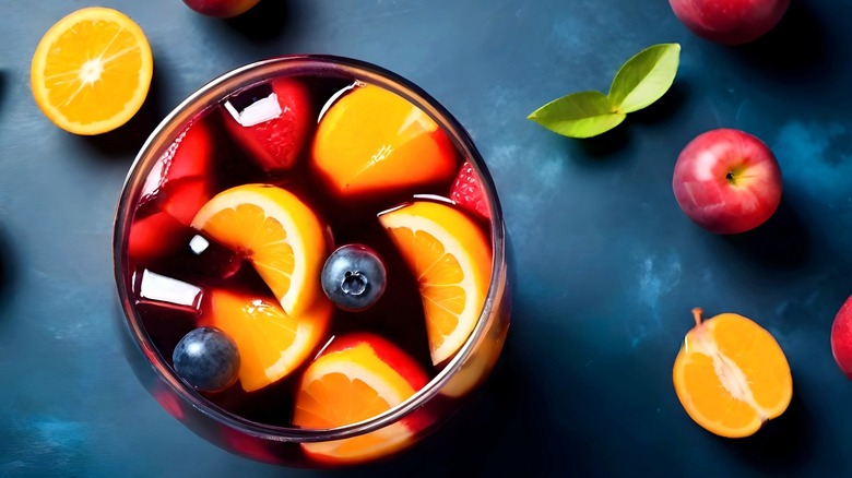 Overview of a glass of sangria with various sliced fruits