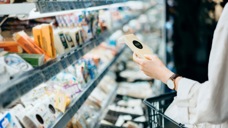 woman shopping for vegan cheese