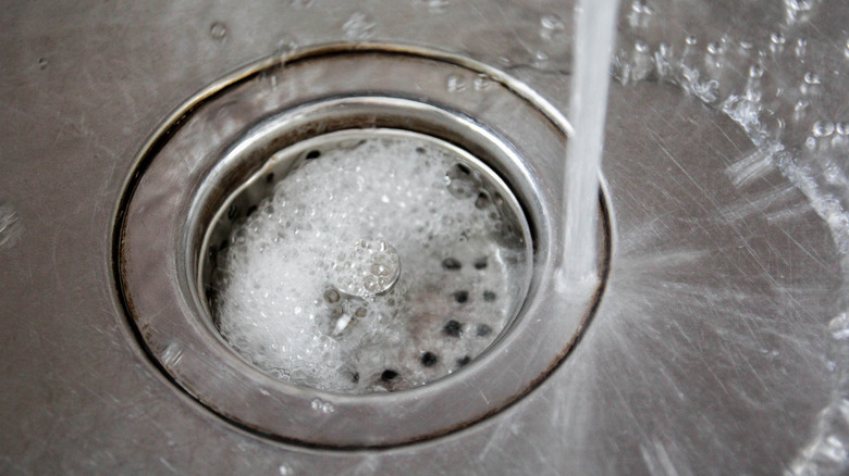 soapy water running into drain in kitchen sink