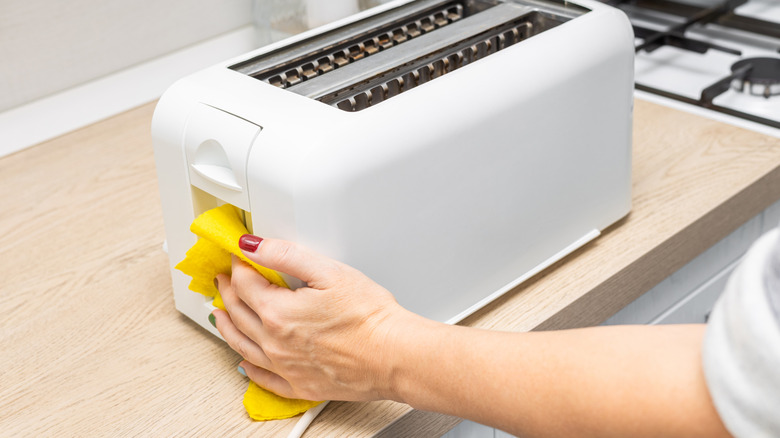 A toaster being cleaned