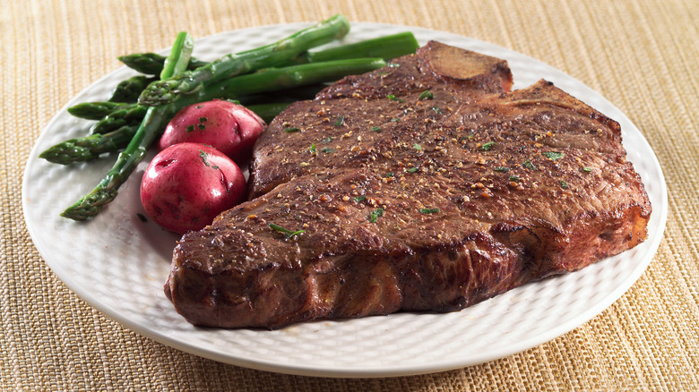 Porterhouse steak plated with vegetables