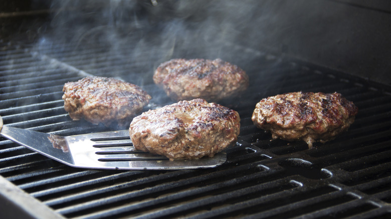 Burgers cooking on grill 