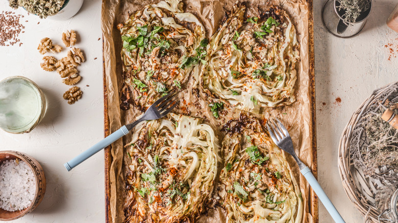 roasted cabbage on a baking sheet with nuts
