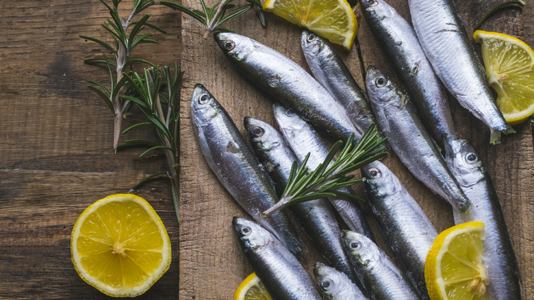 fresh sardines on wooden table