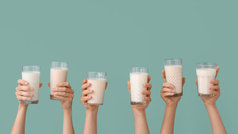 hands vegan milk glasses