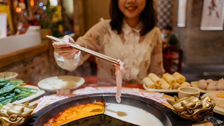 woman eating hot pot and meat 